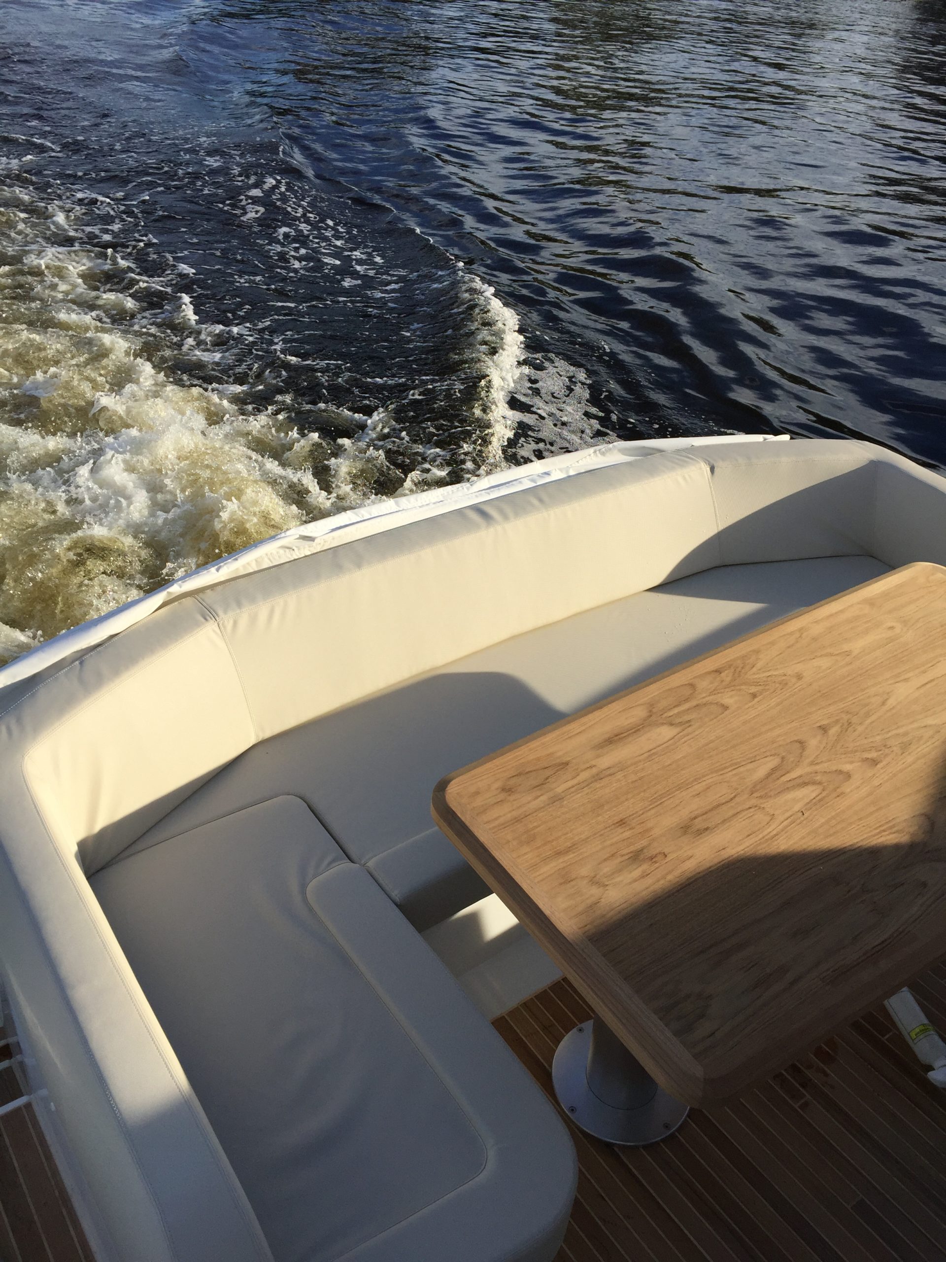 White and black ship on the sea under a blue sky, representing whole-yacht ownership