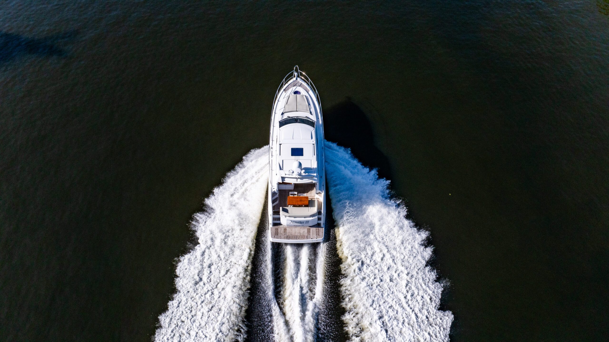 Aerial view of a white motor yacht on calm water off South Florida