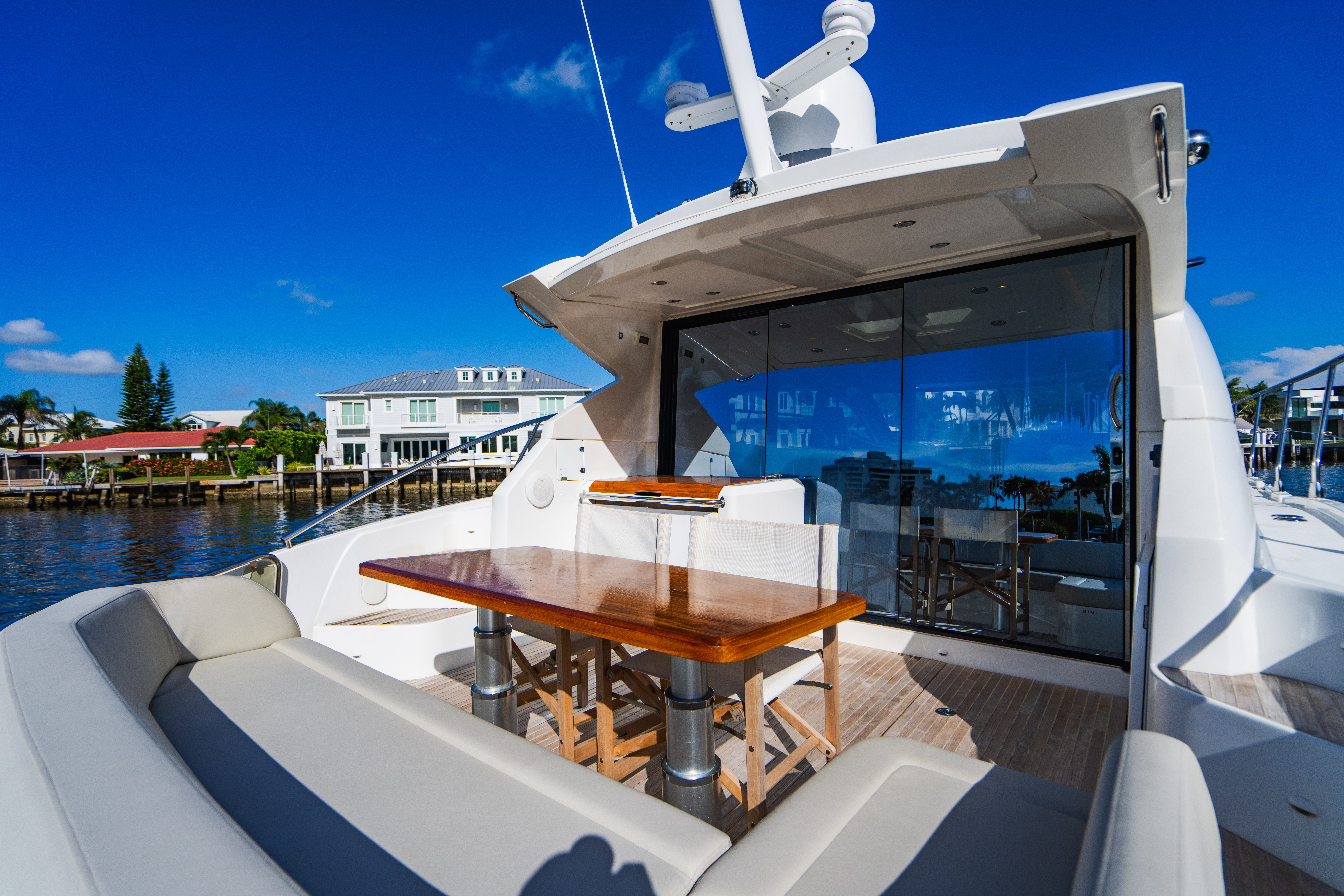 Luxury yacht on the water near a South Florida shoreline, evoking the Boca Raton coastline